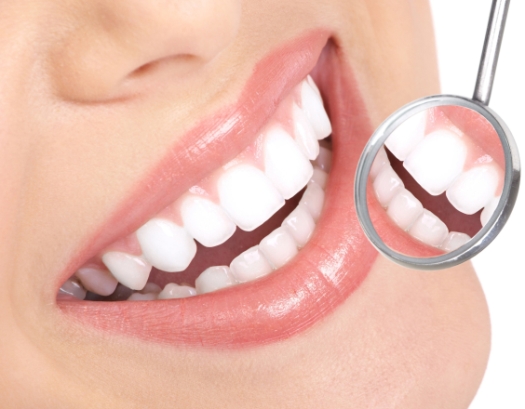 Healthy woman teeth and a dentist mouth mirror